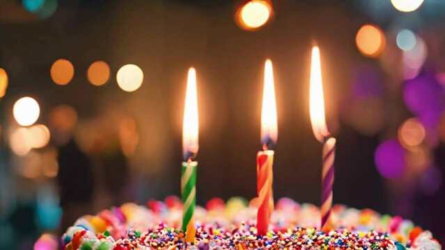 colorful birthday cake with candles and bokeh lights background