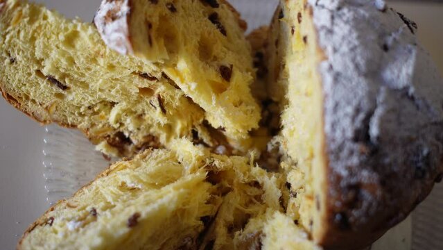 Panettone, Colomba.
Tall, soft, decorated with candied fruits and raisins. Bakery products made from soft dough. Sweet holiday bread sprinkled with powdered sugar. Traditional Italian Christmas pastri