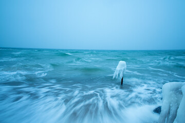 Winter cold coast and ice floes. long shutter speed, blurred wave movement