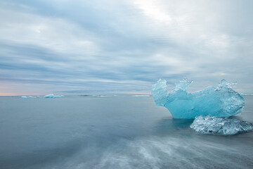   ice floes in the water on the ocean shore at dawn. Jökulsárlón. glacier lagoon in Iceland....