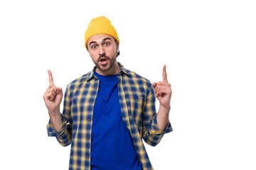 handsome young hipster man in cap and shirt gesturing actively on white background with copy space
