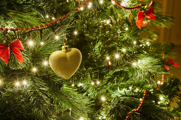 Close-Up of Christmas Tree with Ornaments and Garland with Lights