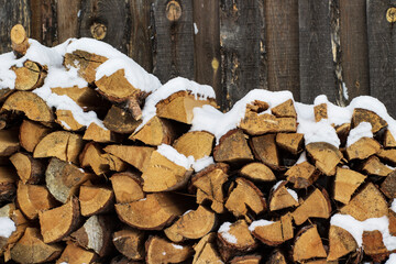 Stack of firewood snow covered in winter	