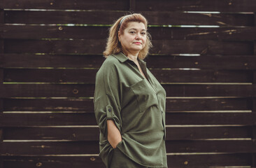 Mature plus size lady outdoor portrait at street. Middle aged People psychology concept