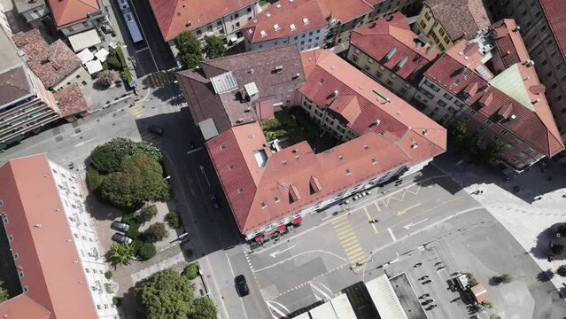 Aerial view over the streets of Lugano, Switzerland. City center, cars moving, red rooftops.