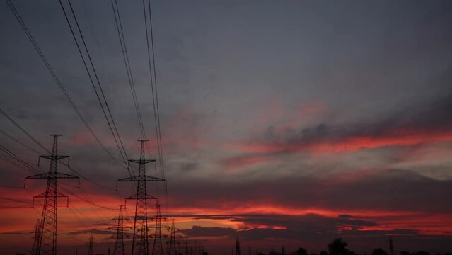 Large power poles and beautiful orange dramatic sunset