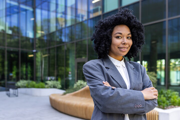 Portrait of a smiling and confident African American businesswoman standing outside an office...