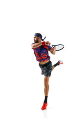Full-length dynamic image of athletic bearded man, tennis player in motion, practicing, playing...