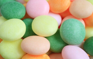 Fototapeta na wymiar Pile of Pastel Fruity Colored Round Shaped Candies for Background and Wallpaper
