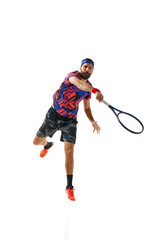 Bearded young man in colorful uniform raining, playing tennis hitting ball with racket isolated over white studio background. Concept of professional sport, movement, competition, action. Ad