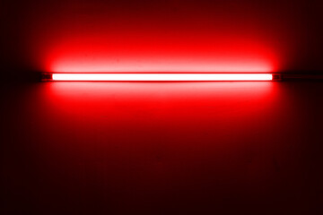 Red neon lamp on a white wall for design