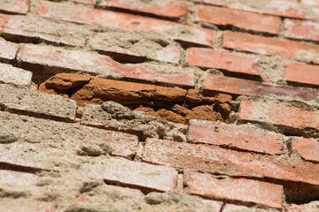 Closeup of old red brick wall with selective focus on foreground