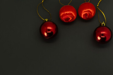 Christmas background with red baubles on black background