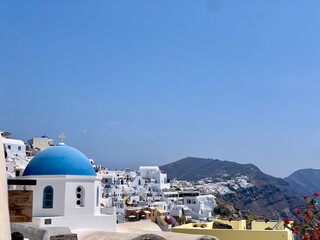 Beautiful Oia town on Santorini island, Greece. Traditional white architecture and greek orthodox churches with blue domes over the Caldera, Aegean sea in the beautiful town of Oia.	 - obrazy, fototapety, plakaty