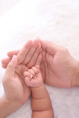 Close up parent and child hands