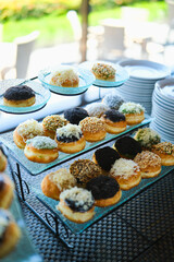 A dessert contains of donuts with various topping served during lunch in a restaurant.