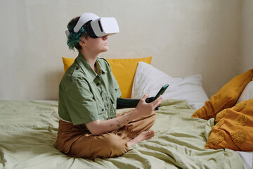 Teenage girl with prosthetic arm playing virtual reality game
