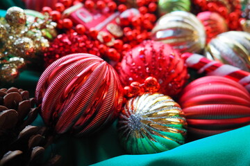 New Year's Christmas balls, tinsel and decorations close up. A lot of decoration of golden, red,...