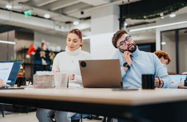 Diverse business team collaborating on market analysis, strategy, and financial planning in a corporate office.