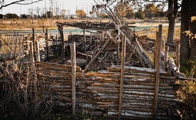 Bushcraft shelter of wood made with logs and sticks with a bed.