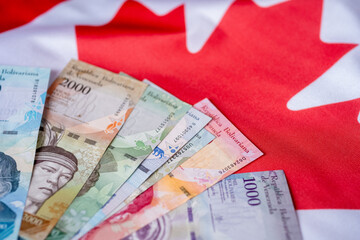 Venezuelan money on canadian flag
