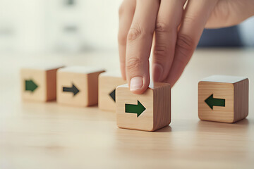 business, people and teamwork concept close up of female hands arranging wooden cubes with arrows