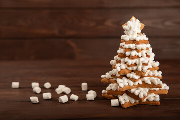 Merry Christmas! Gingerbread Christmas tree cookies with icing on a table texture background. Atmospheric Christmas sweets. Gingerbread. Christmas cookies. Place for text. Copy space.