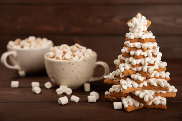Merry Christmas! Gingerbread Christmas tree cookies with icing on a table texture background. Atmospheric Christmas sweets. Gingerbread. Christmas cookies. Place for text. Copy space.
