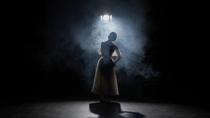 Silhouette of female on black background under spotlight projector in studio. Ballerina in white tulle dancing slow choreography in smoke. © kinomaster