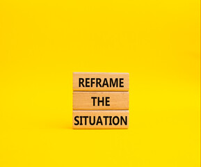 Reframe the situation symbol. Concept words Reframe the situation on wooden blocks. Beautiful yellow background. Business concept. Copy space.