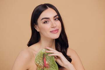 Beauty portrait of attractive young naked woman posing with flower