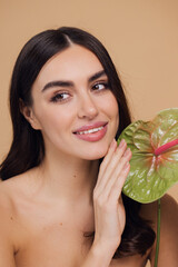 Beauty portrait of attractive young naked woman posing with flower