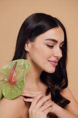 Beauty portrait of attractive young naked woman posing with flower