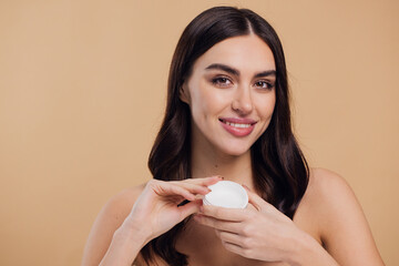 Beauty portrait of half naked woman with soft healthy skin applying face cream
