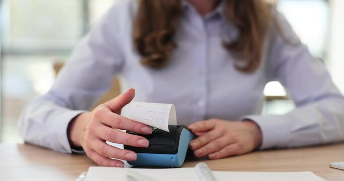 Salesman taking out receipt from cash register in office closeup 4k movie slow motion