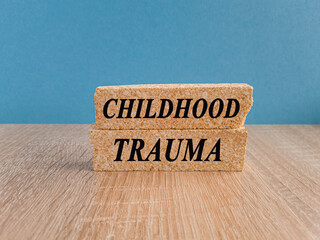 Childhood trauma symbol. Concept words Childhood trauma on brick blocks. Beautiful wooden table,...