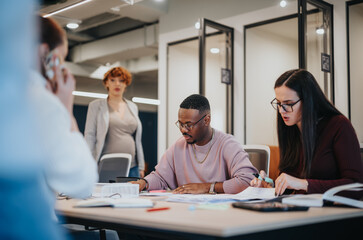 Diverse business team working on successful project completion in office.
