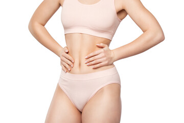 Girl pulls the skin on the abdomen, showing the body fat. Treatment and disposal of excess weight, the deposition of subcutaneous fat.