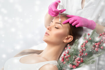 Cosmetologist makes rejuvenating anti wrinkle injections on the face of a beautiful woman. Female...