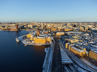 Fototapeta premium Panorama of the old town of Stockholm, island of Riddarholmen and district of Kungsholmen, in winter with snow and sunshine.