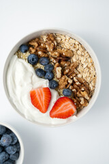 oatmeal porridge with blueberries, strawberries, nuts for healthy breakfast