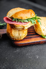 sandwich bun, sausage, salami, arugula, green lettuce ready to eat cooking appetizer meal food snack on the table