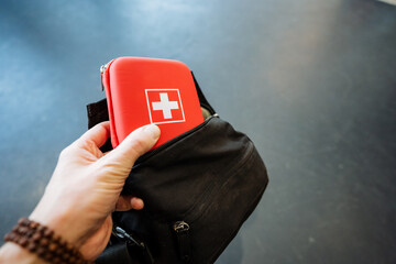 A travel first aid kit is in a bag, take a small box of medicines on the road.