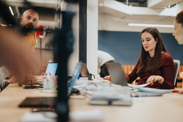 Diverse business team collaborates, discussing financial growth, market analysis, and sales...