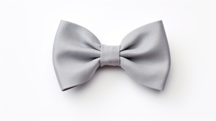  a close up of a bow tie on top of a white surface with a white wall in the back ground.