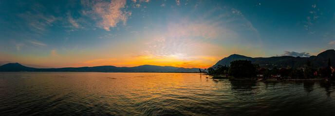 Sunset over a lake with clouds and colors in the sky. A lake from Mexico named Chapala.