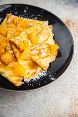 crepe sweet pancake orange fruit syrup fresh dessert eating cooking appetizer meal food snack on the table copy space food background rustic top view