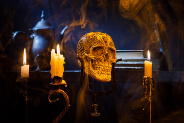 Still life. Human skull and candles, low key photography, decoration