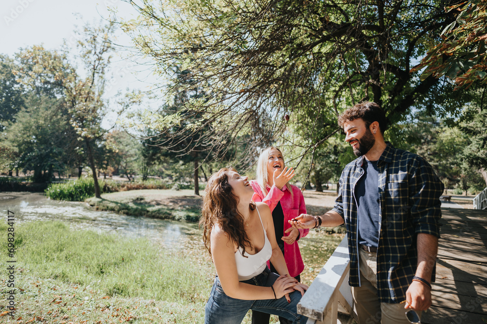 Wall mural carefree friends enjoy a sunny day in a green park, talking, laughing, and embracing their freedom. 