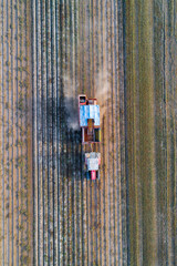 drone view of agricultural machinery working in the potato fields